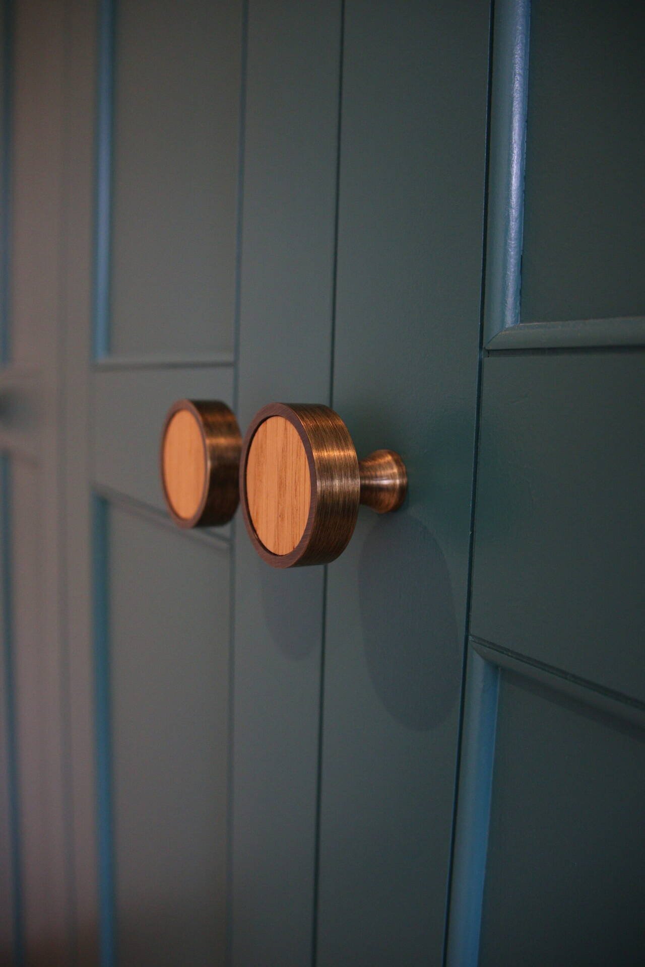 Copper handles on painted cupboard doors