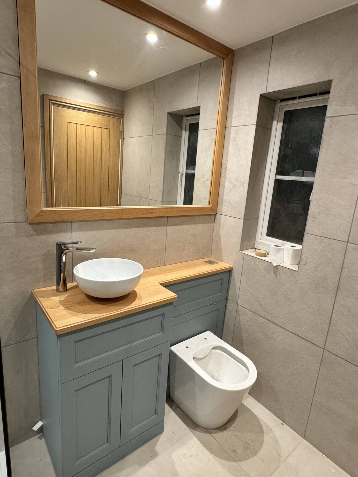 Painted bathroom vanity unit with solid oak top and oak framed mirror