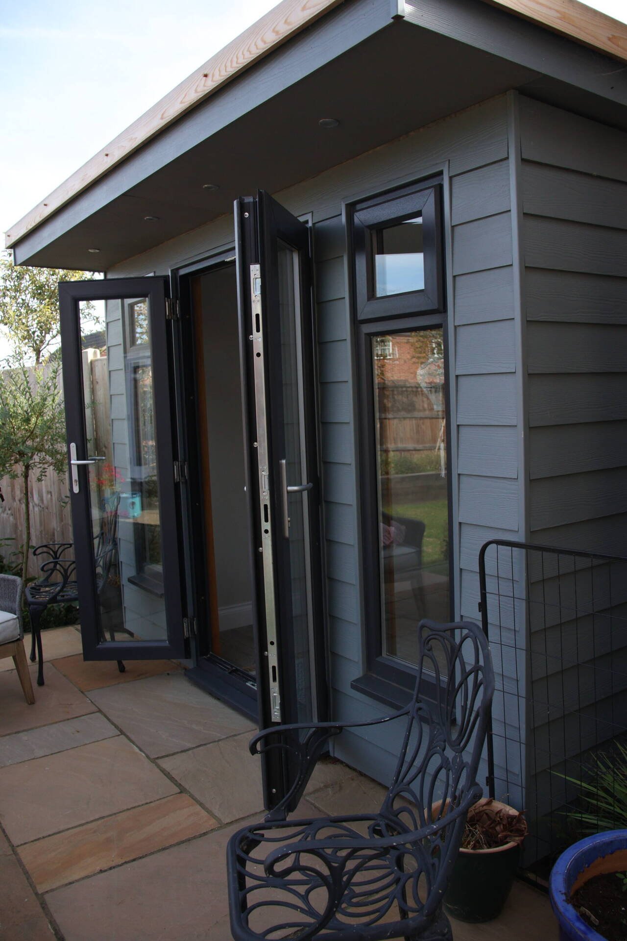 Timber garden room with grey cladding and bifold doors